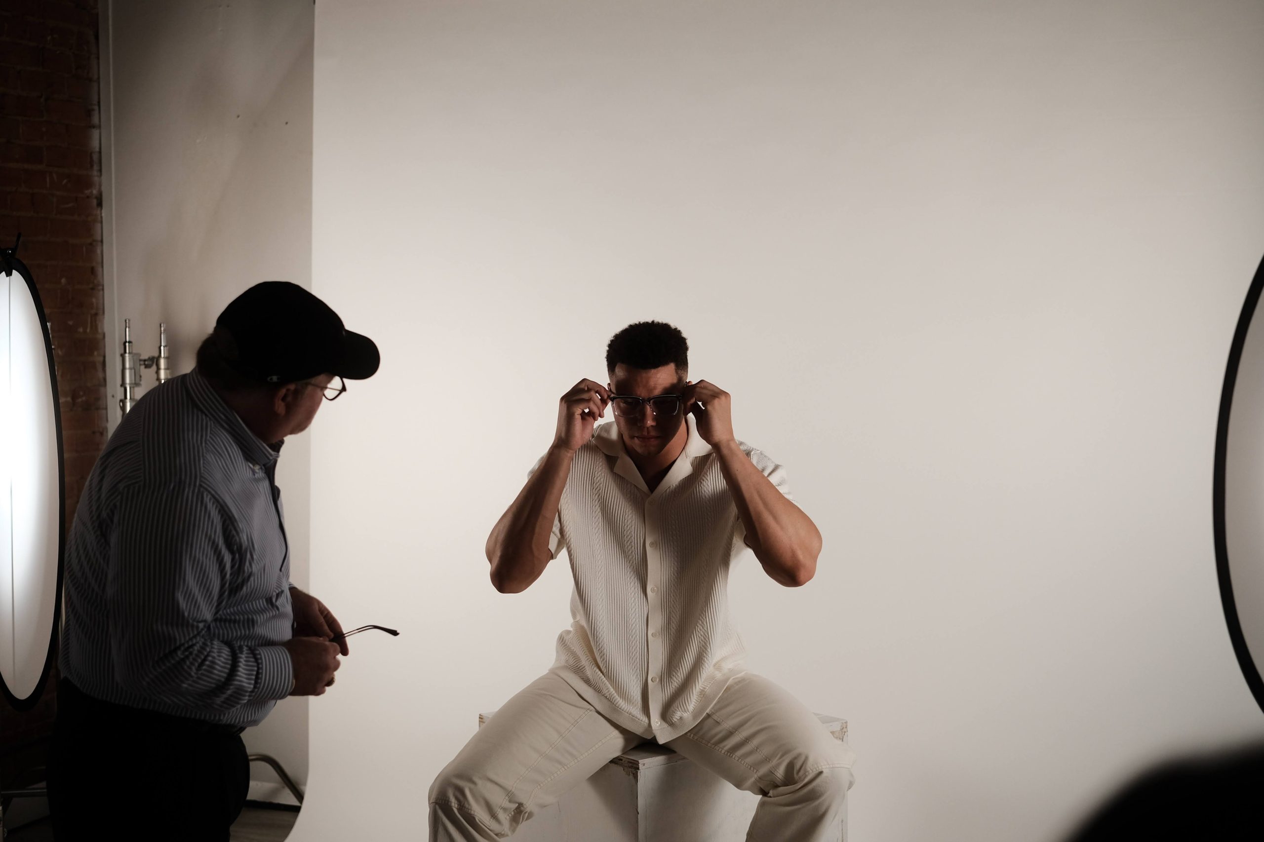 Male model trying on A&A Optical eyeglass frames at a photoshoot
